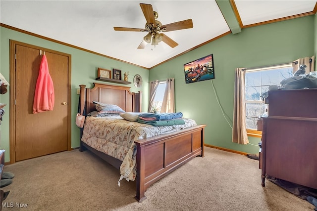 carpeted bedroom with vaulted ceiling with beams, a ceiling fan, baseboards, and ornamental molding