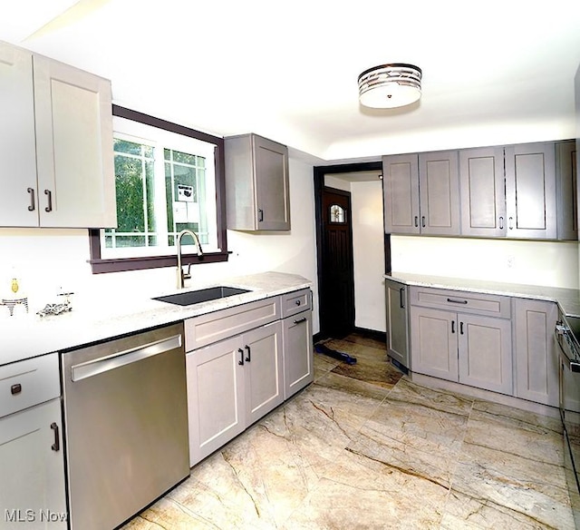 kitchen featuring a sink, dishwasher, gray cabinets, and electric stove