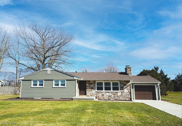 single story home with a chimney, an attached garage, concrete driveway, and a front lawn