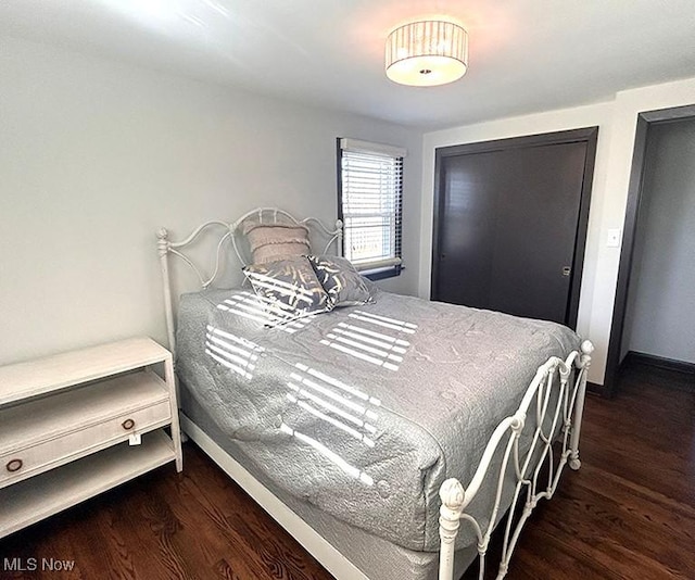 bedroom with baseboards and wood finished floors