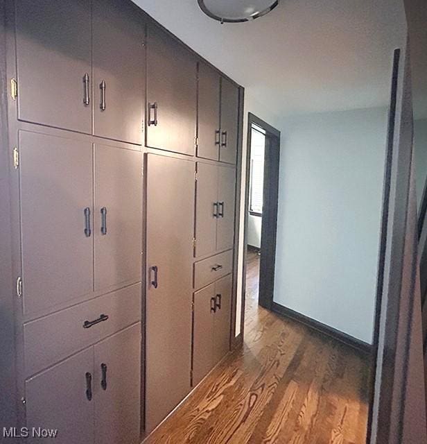 interior space with dark wood-style floors and baseboards