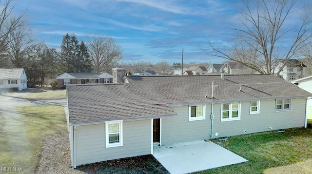 back of house featuring a residential view, roof with shingles, and a patio area