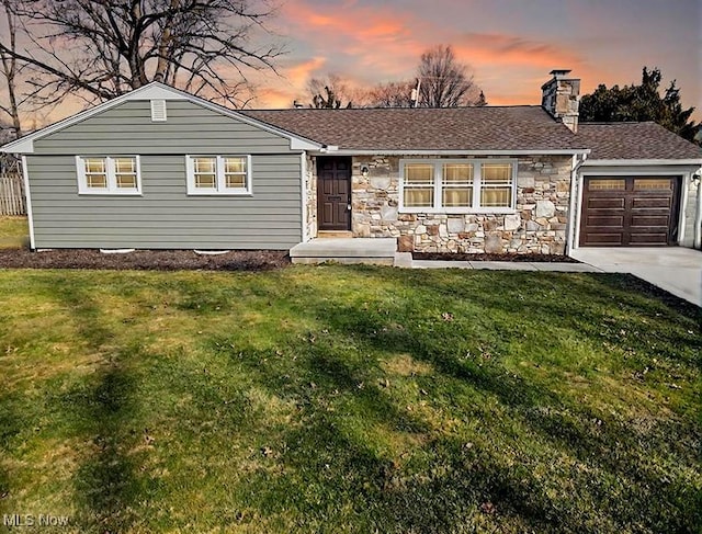 174 N Vine St, Columbiana, OH 44408 - ranch-style home with a garage, driveway, a front yard, stone siding, and a chimney