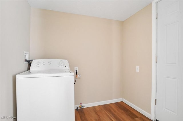 washroom featuring baseboards, washer / clothes dryer, wood finished floors, and laundry area