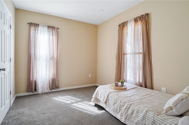 carpeted bedroom with baseboards