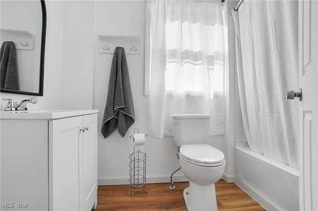 full bath featuring vanity, wood finished floors, baseboards, shower / bath combination with curtain, and toilet