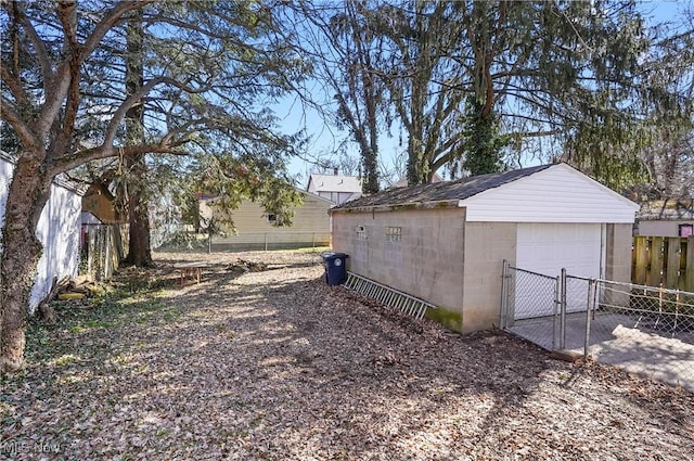 detached garage with fence and driveway