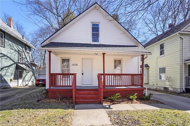 bungalow-style house featuring covered porch and a shingled roof