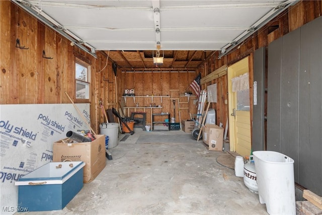 garage featuring wooden walls and a garage door opener