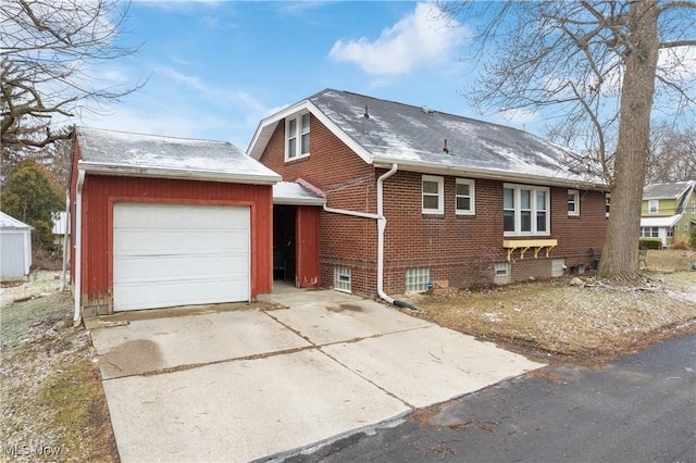 view of front of property featuring a garage, brick siding, and driveway