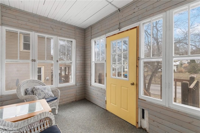 sunroom / solarium with plenty of natural light and wooden ceiling