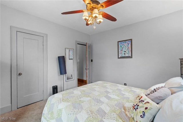 carpeted bedroom featuring a ceiling fan