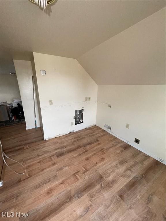 bonus room featuring vaulted ceiling, wood finished floors, and visible vents