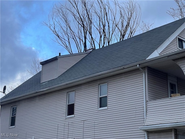 view of home's exterior featuring roof with shingles