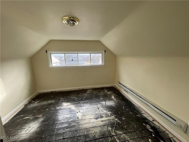 bonus room featuring a baseboard heating unit, lofted ceiling, baseboards, and hardwood / wood-style floors