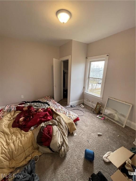 bedroom featuring carpet flooring and baseboards