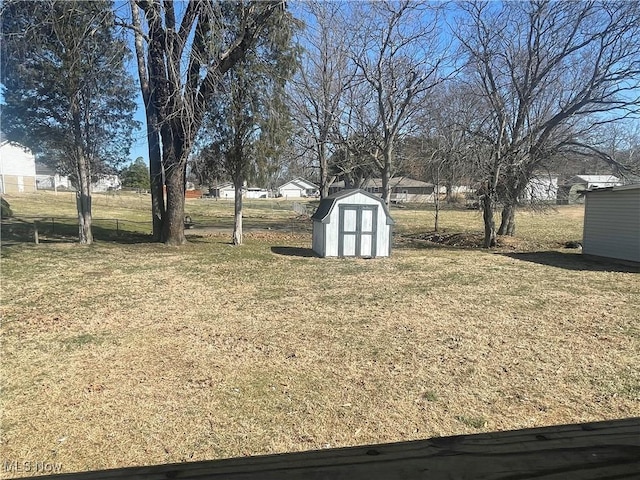 view of yard with a storage shed and an outdoor structure