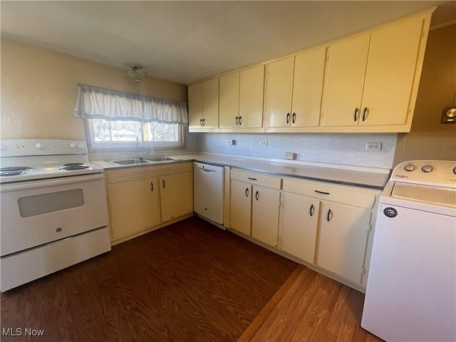 kitchen featuring dark wood finished floors, white appliances, washer / clothes dryer, and a sink