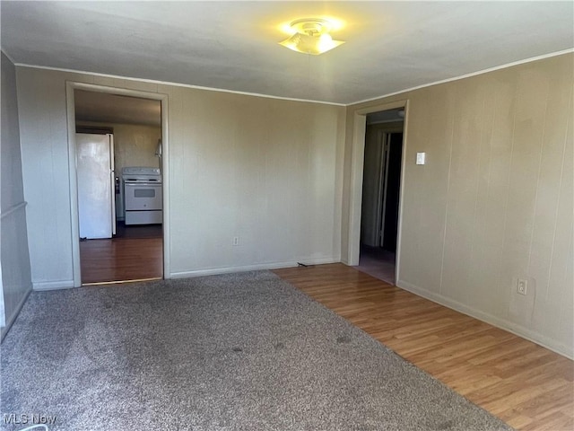 empty room featuring crown molding and wood finished floors