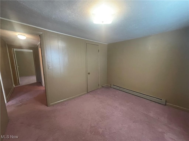 unfurnished bedroom with a textured ceiling, light colored carpet, a closet, and a baseboard radiator