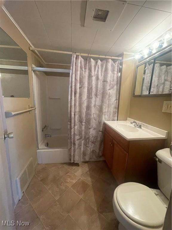 full bath with vanity, shower / tub combo, toilet, and visible vents