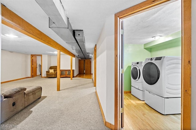 washroom featuring baseboards, separate washer and dryer, laundry area, and carpet