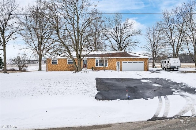 view of front of house featuring brick siding and a garage