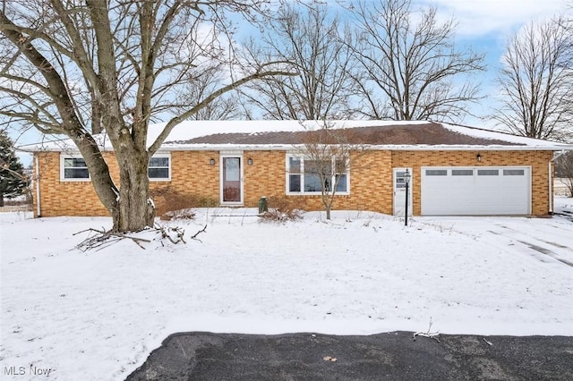 single story home with brick siding and a garage