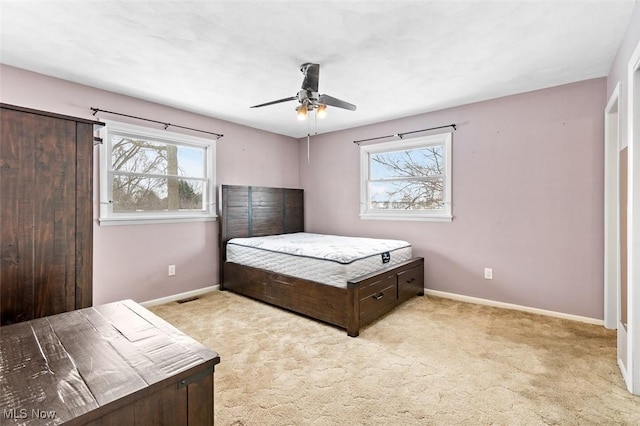 bedroom featuring ceiling fan, baseboards, and carpet