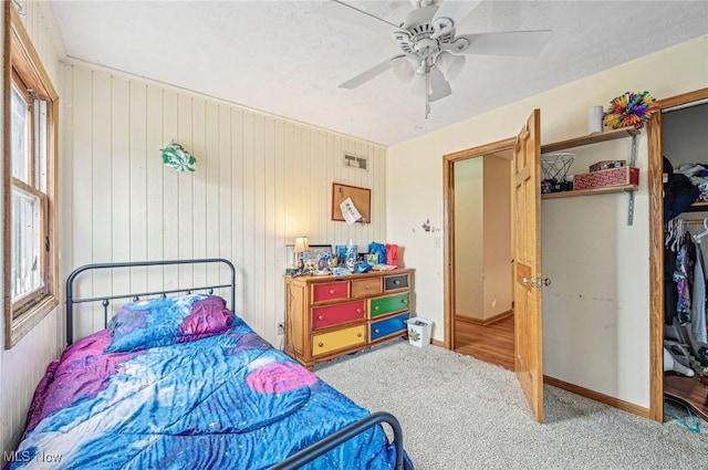 carpeted bedroom featuring multiple windows, baseboards, and ceiling fan