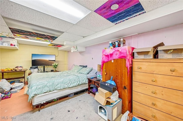 carpeted bedroom with a paneled ceiling