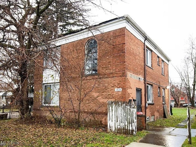 view of side of property with brick siding