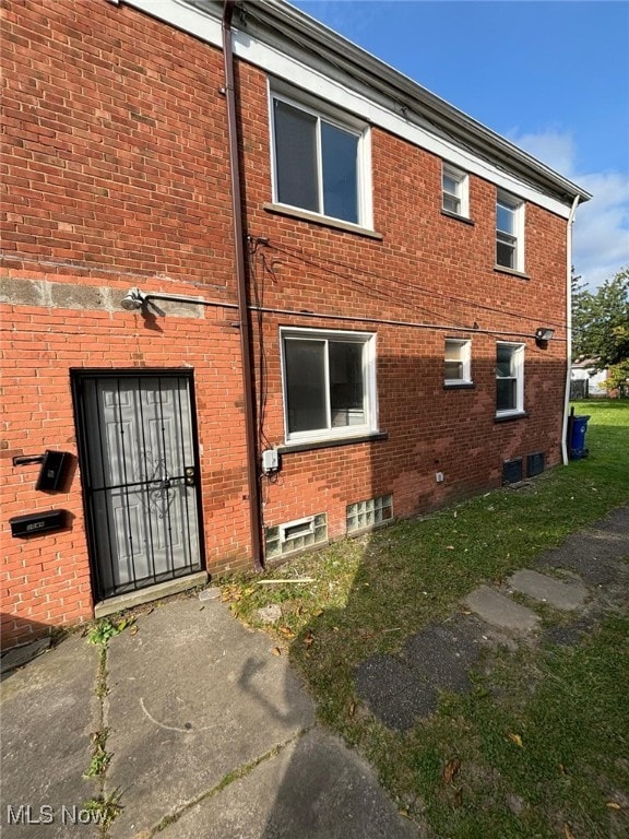 back of house with brick siding