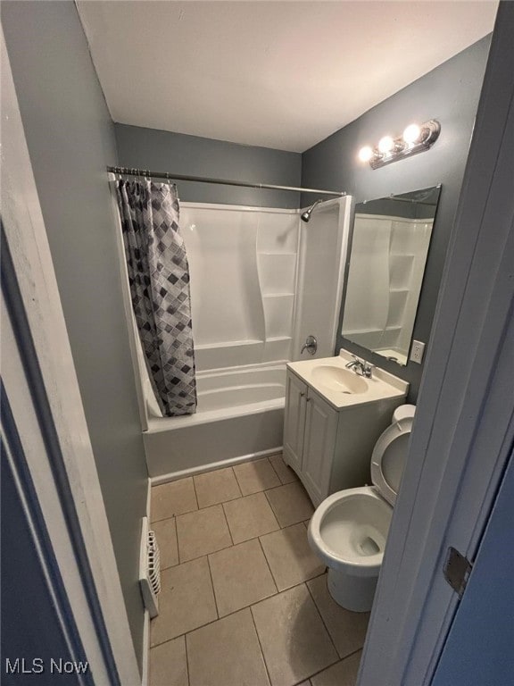 full bath with tile patterned flooring, toilet, vanity, and shower / tub combo with curtain