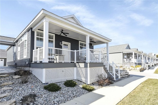 view of front facade featuring stairs, covered porch, and ceiling fan