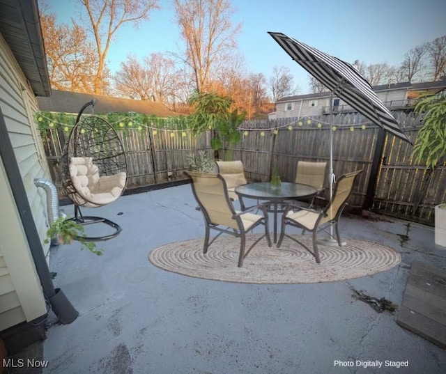 view of patio / terrace featuring outdoor dining space and fence