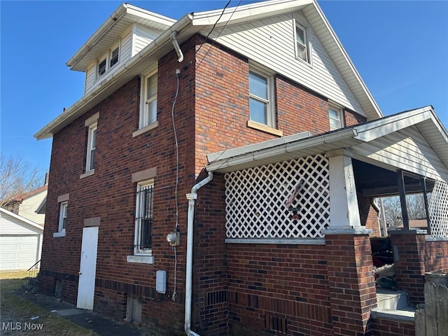 view of side of home featuring brick siding