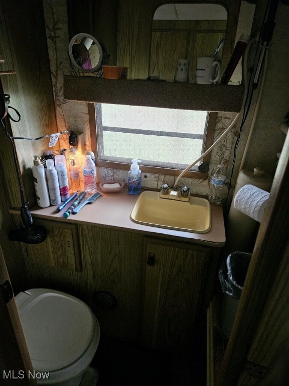 half bath featuring toilet and vanity