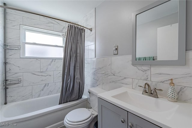 bathroom with shower / bath combo with shower curtain, toilet, tile walls, and vanity