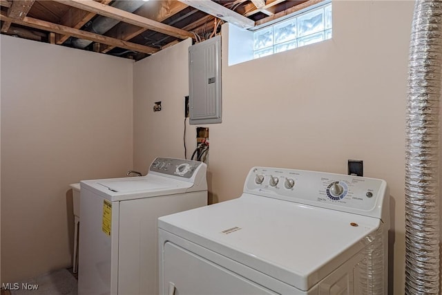 washroom featuring laundry area, electric panel, and washing machine and clothes dryer