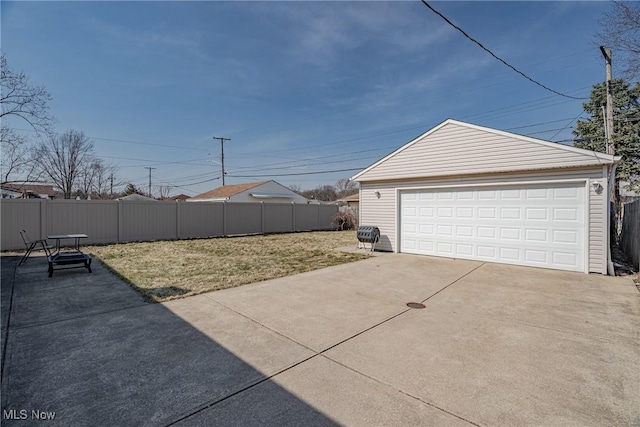 exterior space with a detached garage, an outdoor structure, and fence