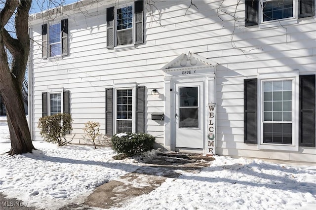 view of snow covered property entrance