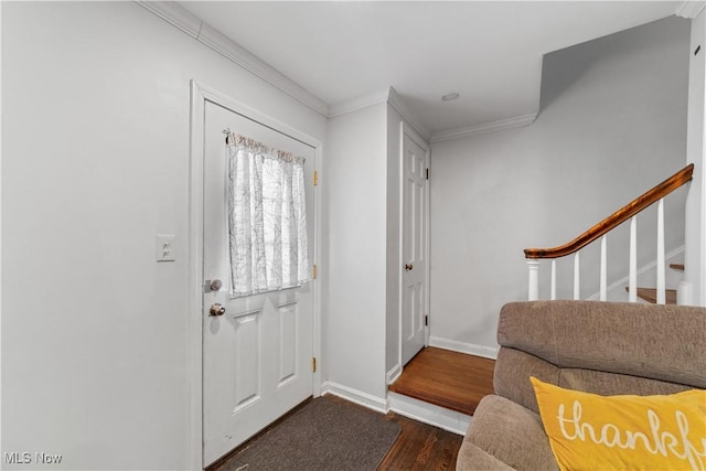 entrance foyer featuring dark wood-style floors, stairway, crown molding, and baseboards