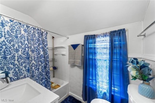 full bathroom featuring toilet, shower / tub combo with curtain, and a sink