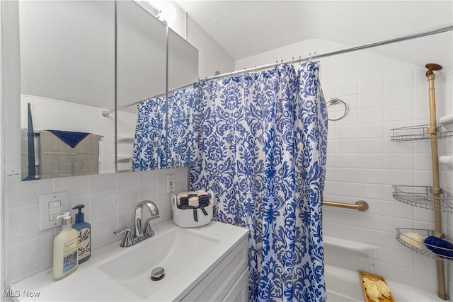 full bath featuring tasteful backsplash, shower / bath combination with curtain, and vanity