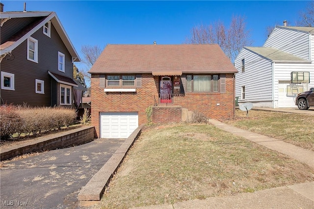 bungalow with brick siding, a front lawn, concrete driveway, and a garage