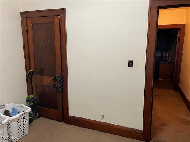 hallway with baseboards and carpet floors