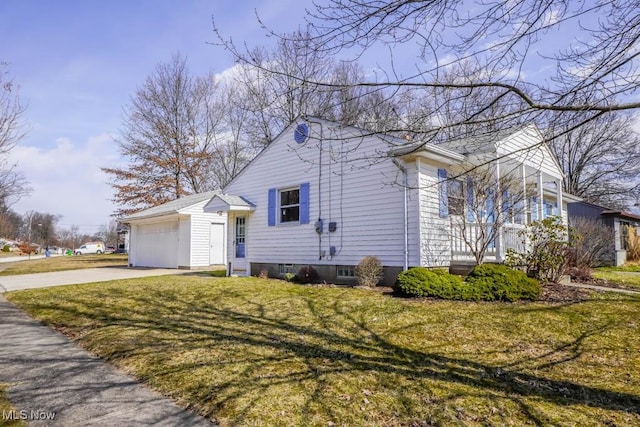 view of home's exterior featuring a garage, driveway, and a yard