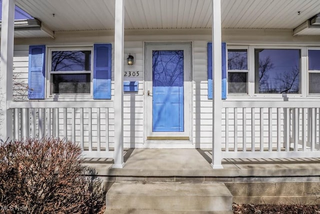 view of exterior entry with a porch