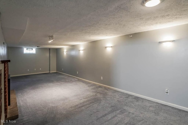 below grade area with baseboards, a textured ceiling, and carpet flooring